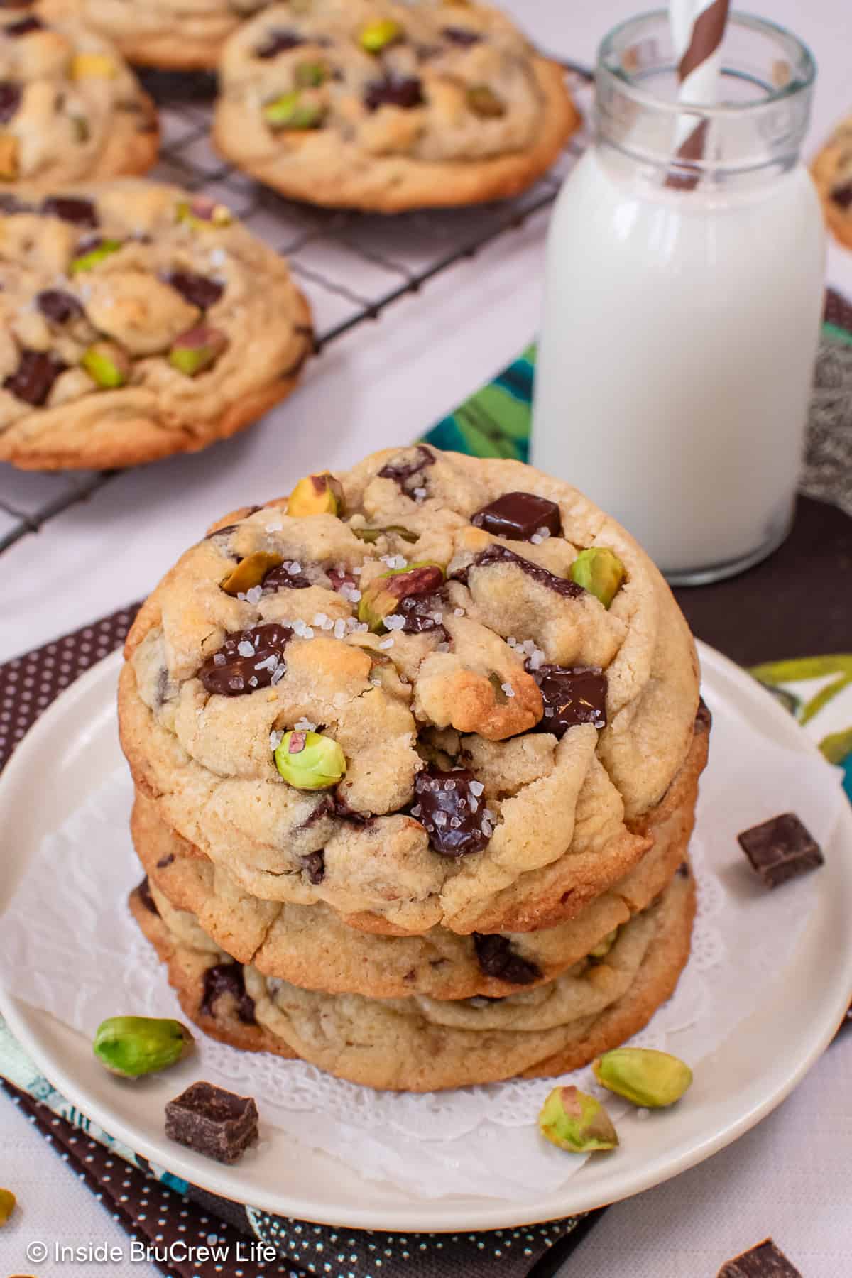 A stack of pistachio toffee cookies on a white plate.