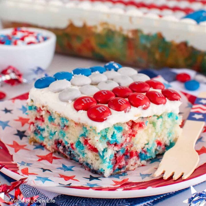 A red white and blue 4th of July cake with sprinkles and an M&M flag.