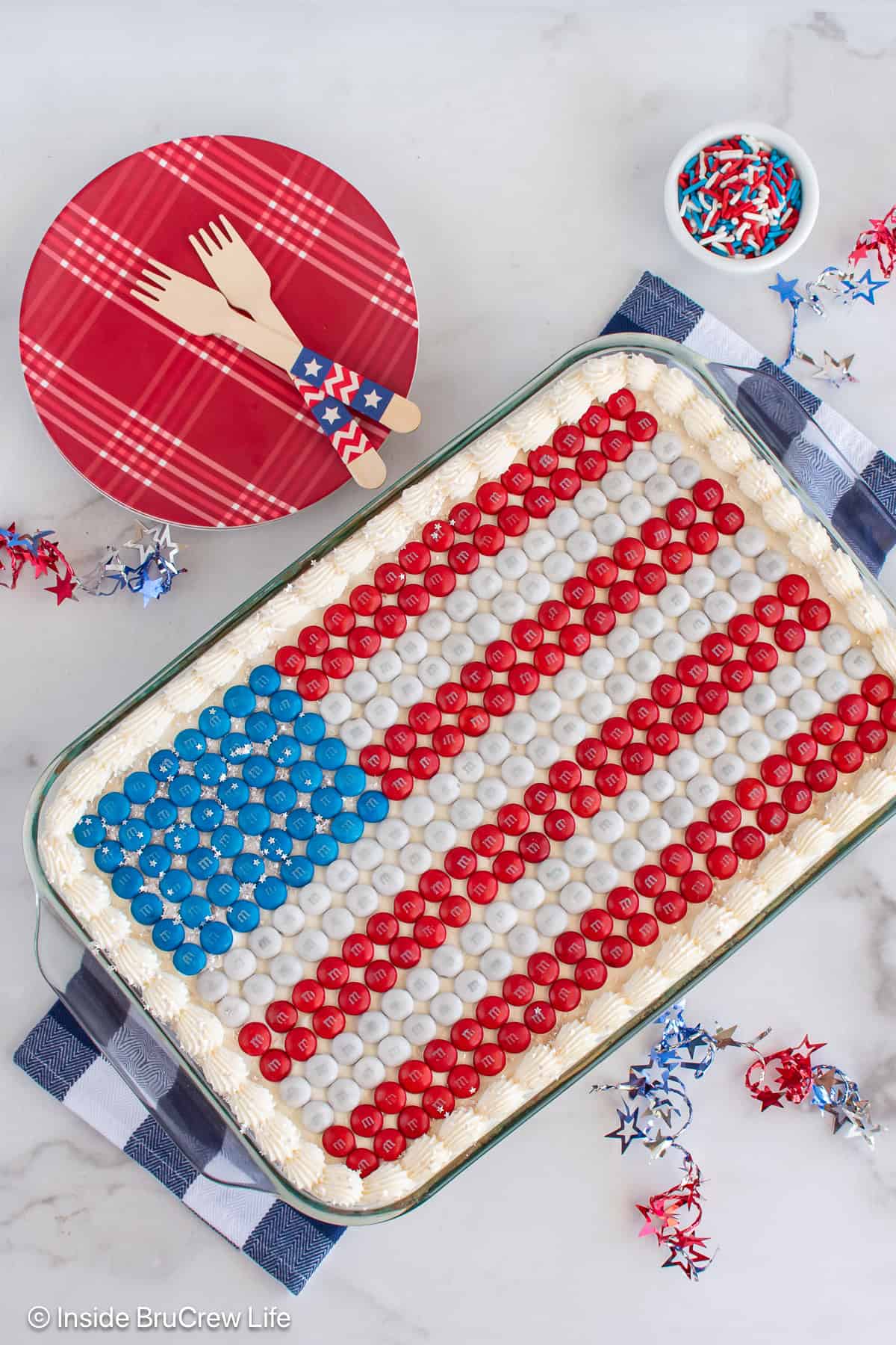 Overhead picture of a 4th of July cake decorated with an M&M flag.