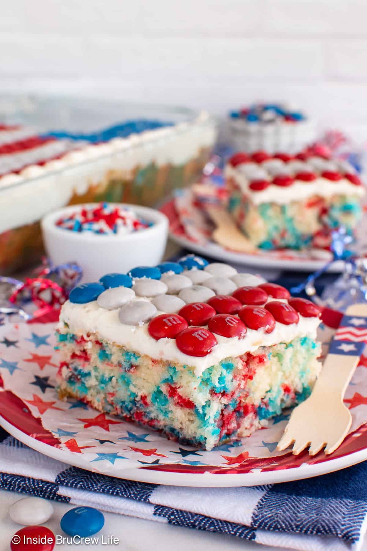 Two pieces of a 4th of July confetti cake on plates.