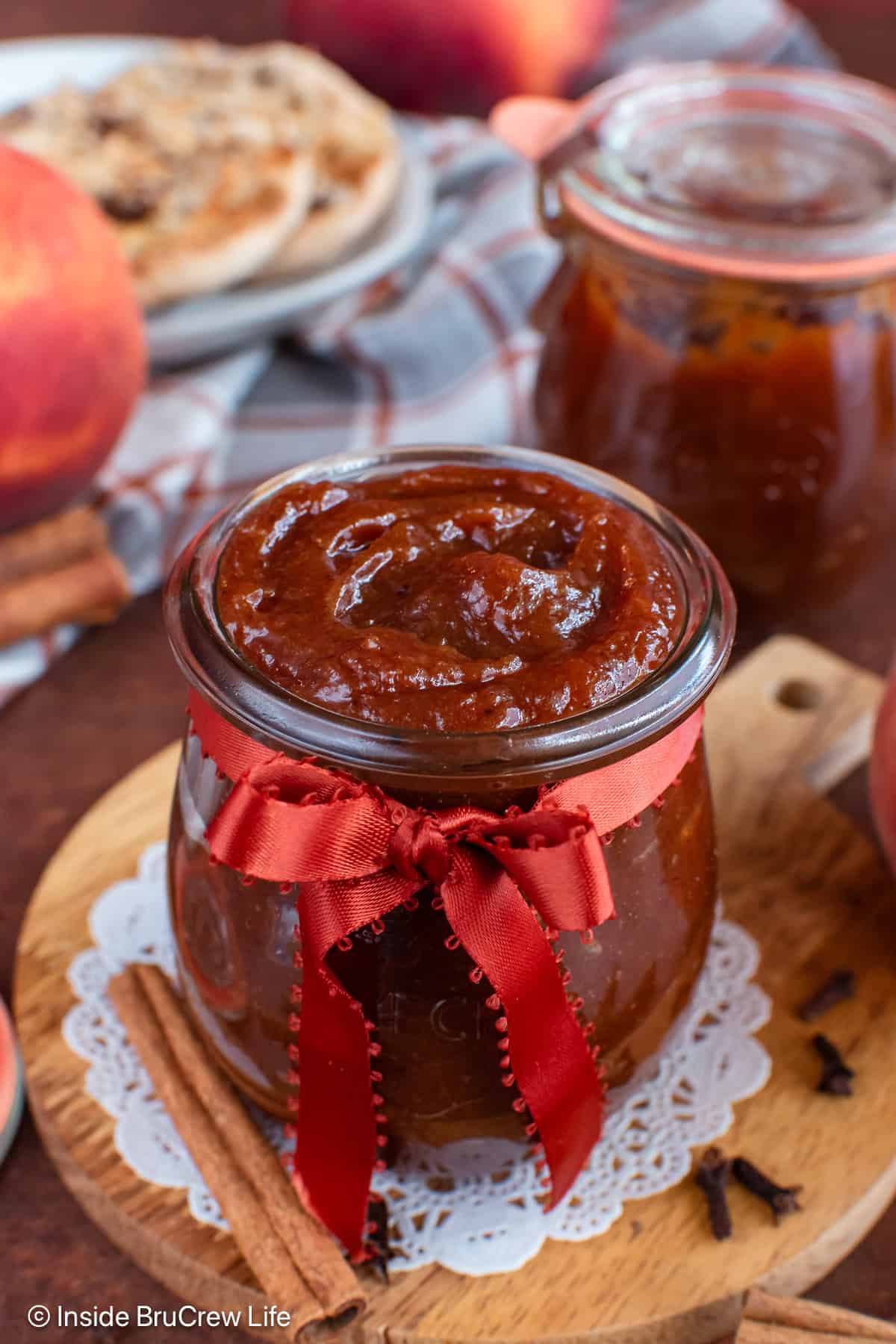 A close up of the peach butter in a glass jar.