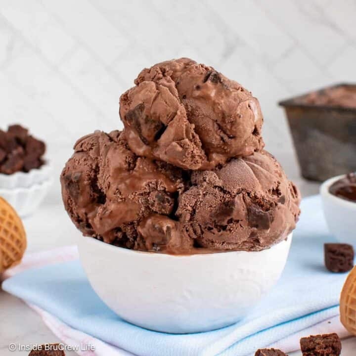 A white bowl filled with scoops of chocolate brownie ice cream.