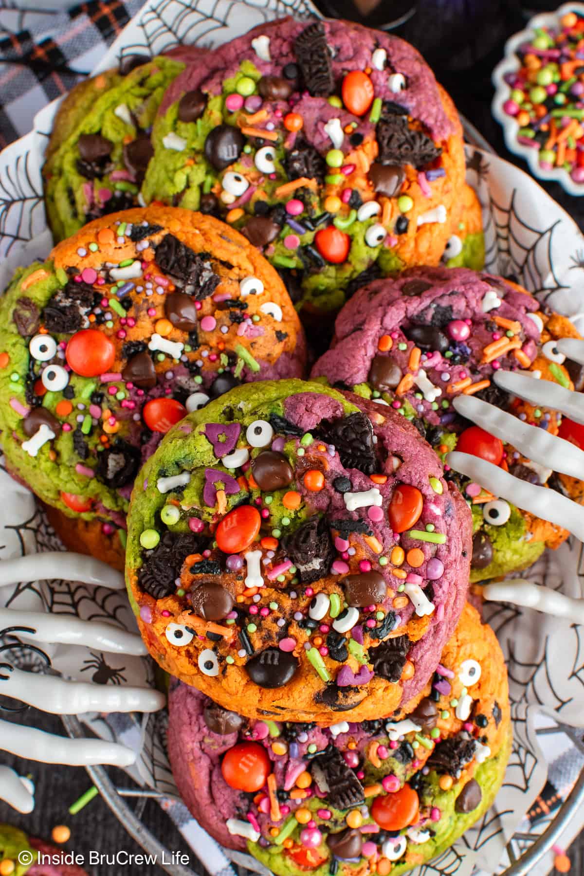 Halloween chocolate chip cookies in a basket with skeleton hands grabbing them.