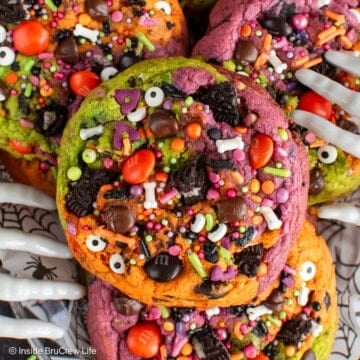 Close up of a Halloween chocolate chip cookie with sprinkles and colorful dough.