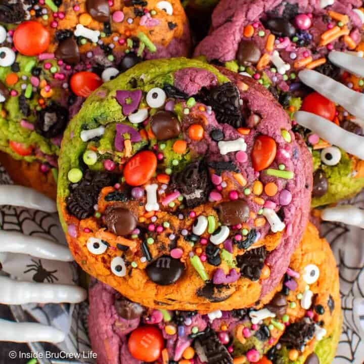 Close up of a Halloween chocolate chip cookie with sprinkles and colorful dough.