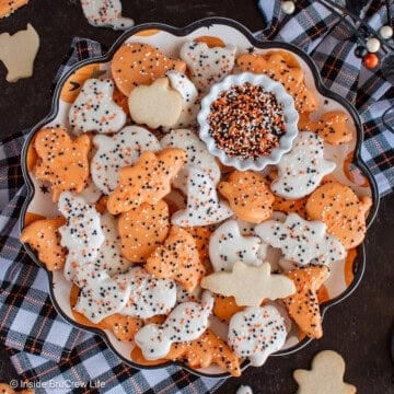 A round black tray filled with Halloween animal cookies.