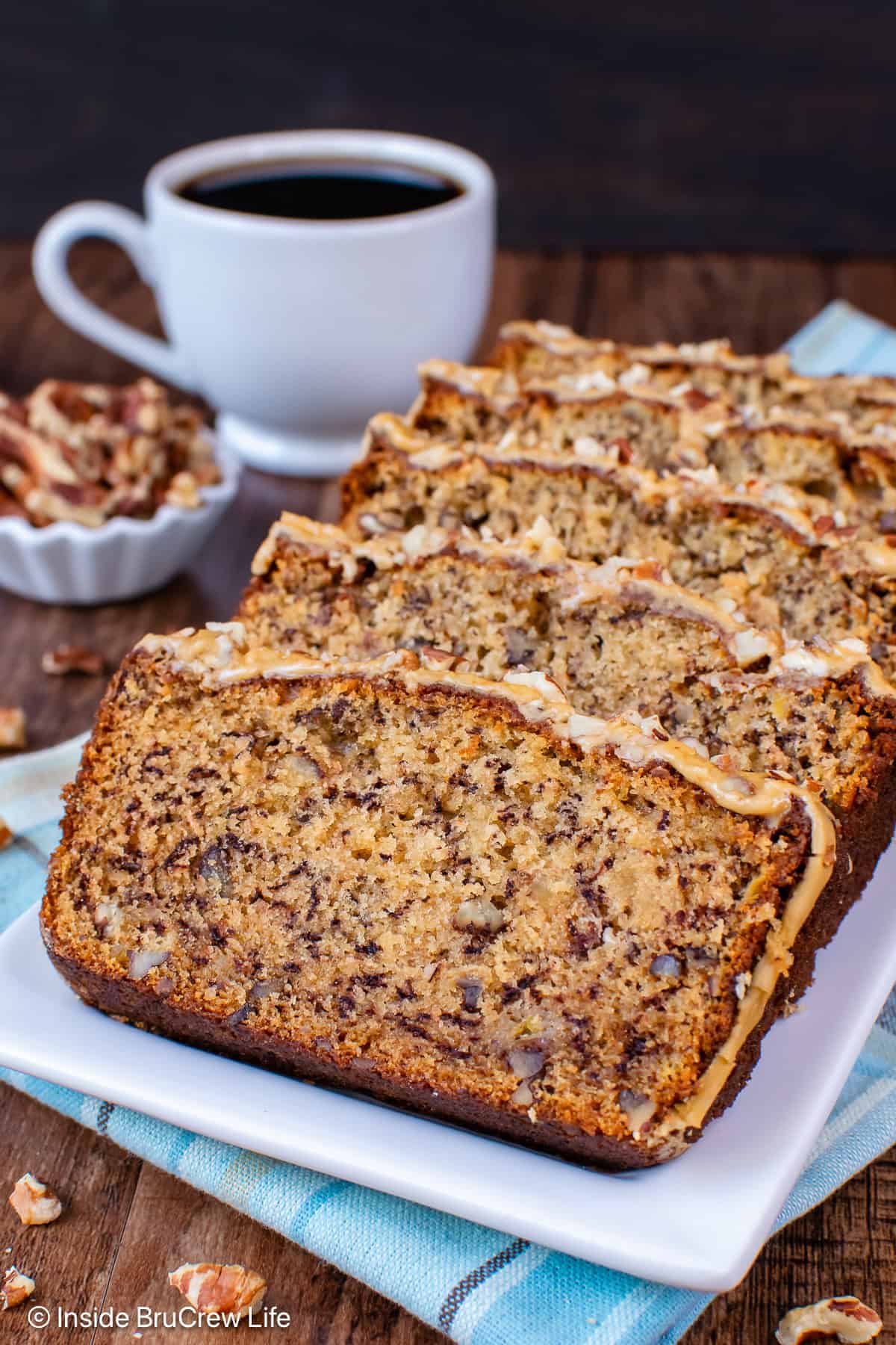 Slices of maple pecan bread on a white plate.